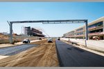 Foto zur News: Komplettierung der ersten Schicht Asphalt des Circuit of The Americas in Austin (Texas/USA): Start- und Zielgerade mit Haupttribüne