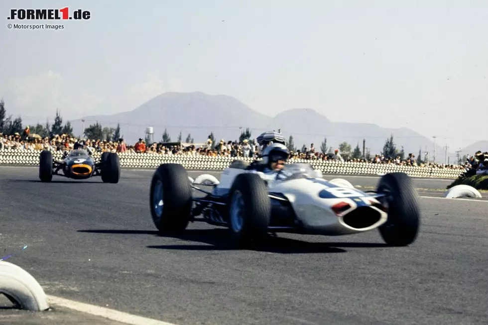 Foto zur News: 1964: Beim WM-Finale in Mexiko kollidiert Ferrari-Fahrer Lorenzo Bandini erst mit Titelkandidat Graham Hill, dann lässt er seinen Teamkollegen John Surtees vorbei für P2. Dieser zweite Platz reicht Surtees zum Titelgewinn.